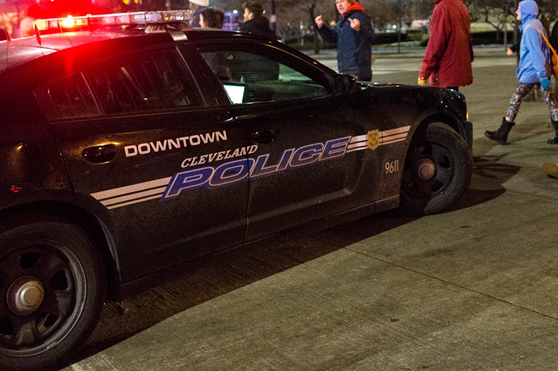 Protestors From Ferguson Join Cleveland Activists For Rallies Against Tamir Rice Shooting
CLEVELAND, OH - DECEMBER 21: Demonstrators march past a police cruiser on S. Roadway outside of Public Square December 21, 2014, in Cleveland, Ohio. Protestors gathered for the second straight day voicing opposition to the shooting death of 12-year old Tamir Rice. (Photo by Angelo Merendino/Getty Images)