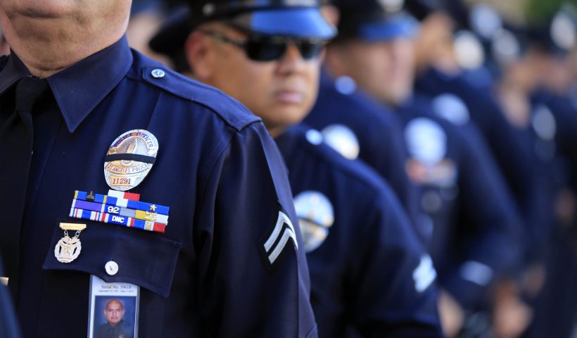 LOS ANGELES, CA - MAY 14: LAPD officers wear a badge honoring fallen officer Roberto Sanchez during a memorial service at the Cathedral of Our Lady Of Angels May 14, 2014 in Los Angeles, California. Family and fellow officers paid their last respects to Sanchez who was killed while on duty when an SUV crashed into his patrol car on May 3rd in the Harbor City. (Photo by Mark Boster-Pool/Getty Images)