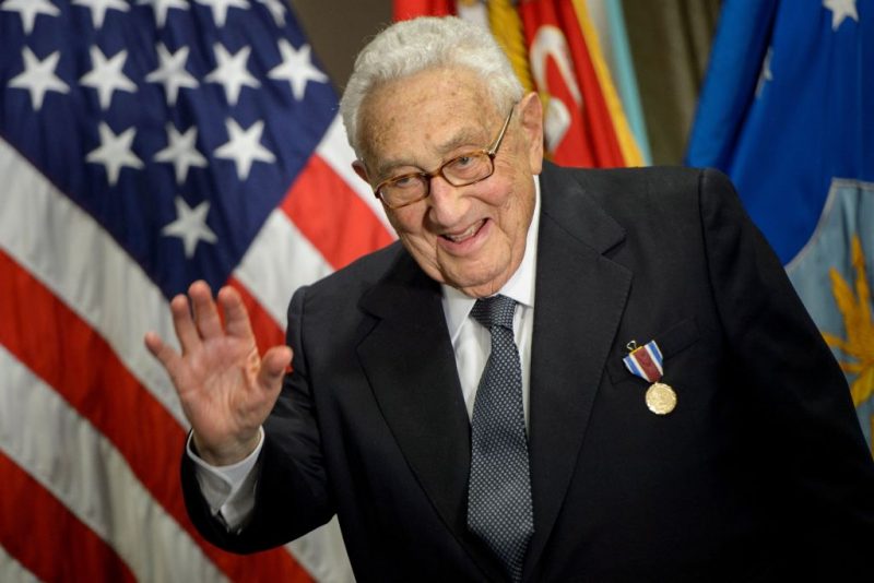 Former US Secretary of State Henry Kissinger waves after receiving an award during a ceremony at the Pentagon honoring his diplomatic career May 9, 2016 in Washington, DC. (Photo by Brendan Smialowski / AFP) (Photo by BRENDAN SMIALOWSKI/AFP via Getty Images)