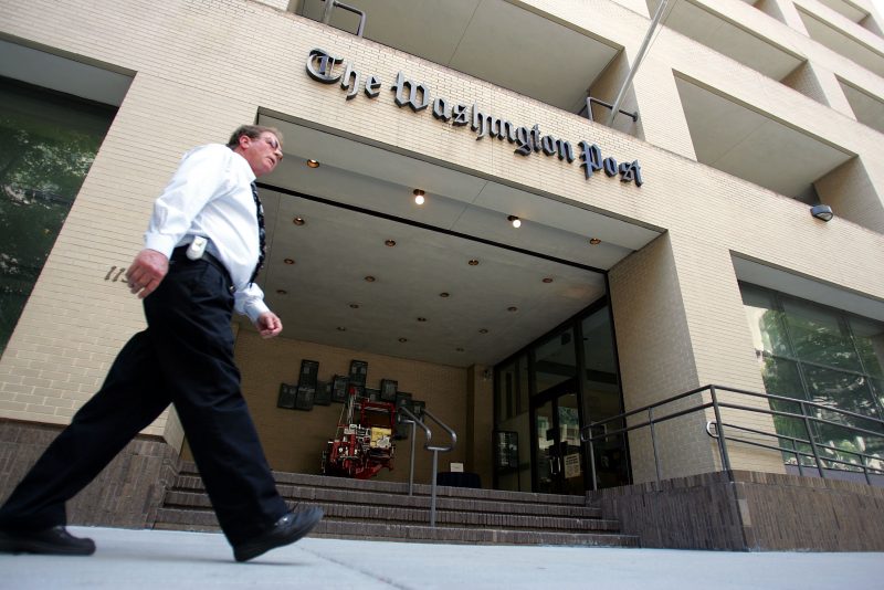 WASHINGTON - MAY 31: A man walks past The Washington Post building May 31, 2005 in Washington, DC. The current edition of Vanity Fair reports that retired FBI official Mark Felt was the "Deep Throat" source who spoke to two Washington Post reporters about the Watergate scandal that forced President Richard Nixon to resign in 1974. (Photo by Joe Raedle/Getty Images)