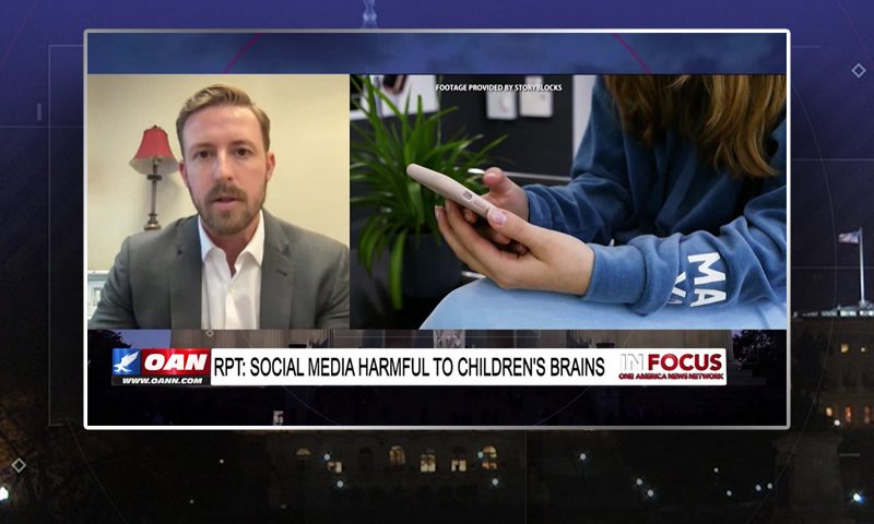 Video still from In Focus on One America News Network showing a split screen of the host on the left side, and on the right side is the guest, Ryan Walters.