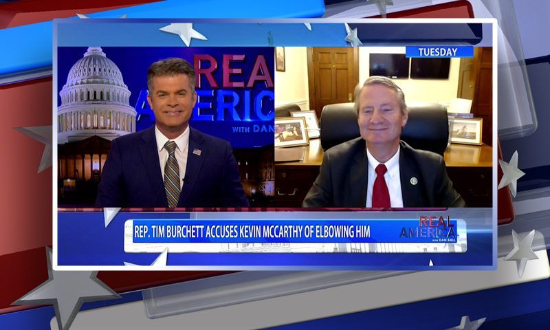 Video still from Real America on One America News Network showing a split screen of the host on the left side, and on the right side is the guest, Rep. Tim Burchett.