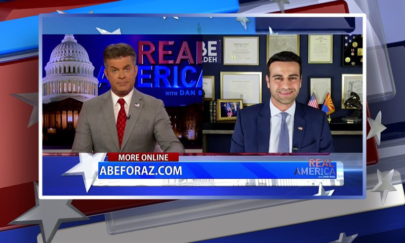 Video still from Real America on One America News Network showing a split screen of the host on the left side, and on the right side is the guest, Abe Hamadeh.