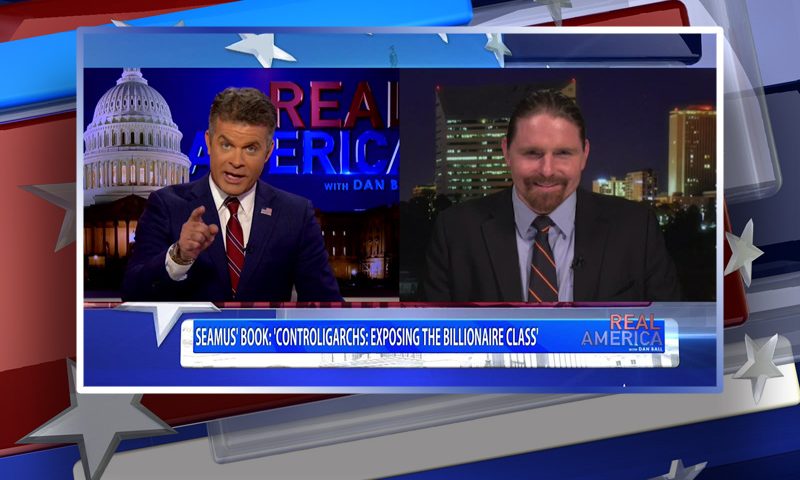 Video still from Real America on One America News Network showing a split screen of the host on the left side, and on the right side is the guest, Seamus Bruner.