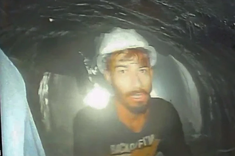 1 of 2 | This screen grab image provided by the Uttarakhand State Disaster Response Force (SDRF) shows one of the 40 workers trapped inside a collansed tunnel in Silkvara in the northern Indian Uttarakhand state India Tuesday. Nov 21 2023 (SDRE via AP)