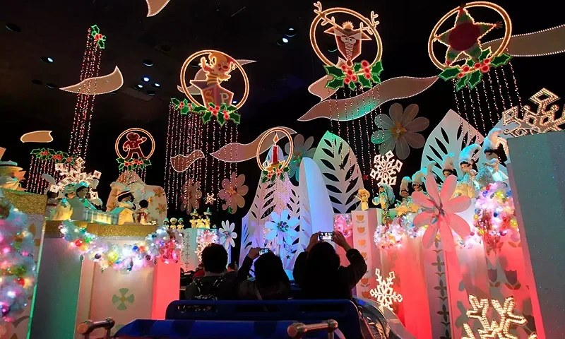 Disneyland visitors cruise through "It's a Small World" holiday, featuring different Christmas and Disneyland visitors cruise through "It's a Small World" holiday, featuring different Christmas and holiday celebrations from around the world with lights and decorations Thursday, Nov. 21, 2013. (Photo by Allen J. Schaben/Los Angeles Times via Getty Images)