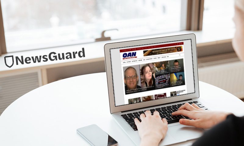 Person browsing OAN homepage on their laptop.