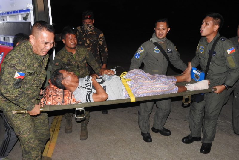A wounded victim of the explosion inside the catholic cathedral is carried to a military plane in Jolo town, sulu province, in southern island of Mindanao on January 28, 2019, to be airlifted to nearby city of Zamboanga for treatment, a day after two explosions tore through the cathedral. - Investigators probing the Catholic cathedral bombing that killed 21 people in the Philippines' restive south said January 28, a group tied to notorious Islamists Abu Sayyaf is the prime suspect. (Photo by NICKEE BUTLANGAN / AFP) (Photo credit should read NICKEE BUTLANGAN/AFP via Getty Images)