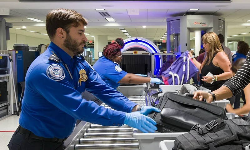 New 3-D Explosives Scanner Installed At TSA Checkpoint At Miami Airport MIAMI, FLORIDA - MAY 21: Transportation Security Administration (TSA) agents help travelers place their bags through the 3-D scanner at the Miami International Airport on May 21, 2019 in Miami, Florida. TSA has begun using the new 3-D computed tomography (CT) scanner in a checkpoint lane to detect explosives and other prohibited items that may be inside carry-on bags. (Photo by Joe Raedle/Getty Images)