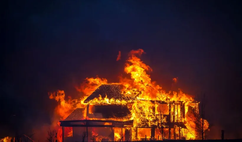 LOUISVILLE, CO - DECEMBER 30: A home burns after a fast moving wildfire swept through the area in the Centennial Heights neighborhood of Louisville, Colorado on December 30, 2021. State officials estimated some 600 homes had already been lost in multiple areas around Boulder County and were fueled by winds that gusted upwards of 100 miles per hour at times during the day. (Photo by Marc Piscotty/Getty Images)