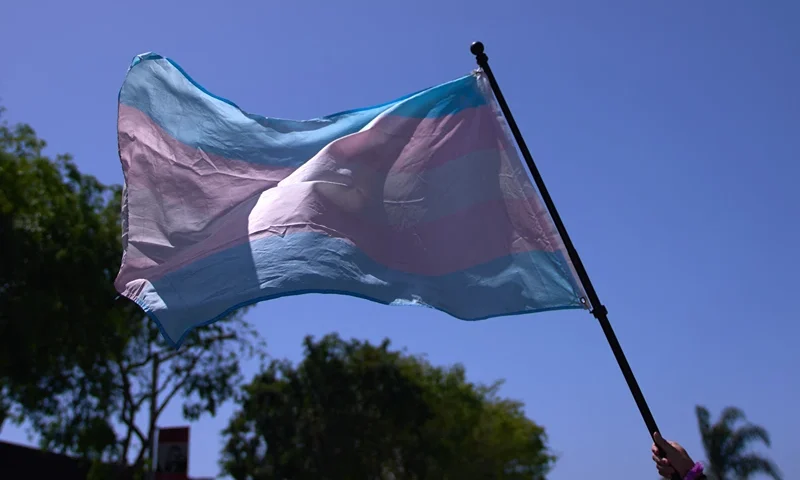 US-POLITICS-SOCIETY-HOLIDAY-LGBTQ+-DEMONSTRATION A Transgender Pride Flag is held above the crowd of LGBTQ+ activists during the Los Angeles LGBT Center's "Drag March LA: The March on Santa Monica Boulevard", in West Hollywood, California, on Easter Sunday April 9, 2023. The march comes in response to more than 400 pieces of legislation targeting the LGBTQ+ community that government officials across the United States have proposed or passed in 2023. (Photo by ALLISON DINNER / AFP) (Photo by ALLISON DINNER/AFP via Getty Images)