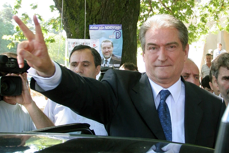 TOPSHOT-ALBANIA-ELECTIONS-BERISHA-VOTE
TOPSHOT - Former Albanian President and leader of the opposition Democratic Party, Sali Berisha, make the sing of victory after casting his ballot in the legislative elections, in Tirana, 03 July 2005. Albanians began voting on Sunday in legislative elections seen as crucial to their country's ambition to join the European Union but overshadowed by fears that whatever the result it will be rejected by the loser and even lead to violence. AFP PHOTO / GENT SHKULLAKU (Photo by GENT SHKULLAKU / AFP) (Photo by GENT SHKULLAKU/AFP via Getty Images)