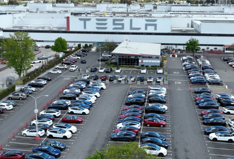 FREMONT, CALIFORNIA - APRIL 20: In an aerial view, Tesla cars sit parked in a lot at the Tesla factory on April 20, 2022 in Fremont, California. Tesla reported first quarter earnings that far exceeded analyst expectations with revenue of $18.76 billion compared to expectations of $17.80 billion. (Photo by Justin Sullivan/Getty Images)