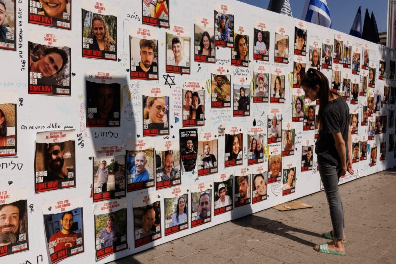 TEL AVIV, ISRAEL - OCTOBER 26: A member of the public looks at a wall displaying pictures of people still held hostage in Gaza, on October 26, 2023 in Tel Aviv, Israel. In the wake of the Oct. 7 attacks by Hamas that left an estimated 1,400 dead and 200 kidnapped, Israel launched a sustained bombardment of the Gaza Strip and threatened a ground invasion to vanquish the militant group that governs the Palestinian territory. But the fate of the hostages, Israelis and foreign nationals who are being held by Hamas in Gaza, as well as international pressure over the humanitarian situation in Gaza, have complicated Israel's military response to the attacks. A timeline for a proposed ground invasion remains unclear. (Photo by Dan Kitwood/Getty Images)