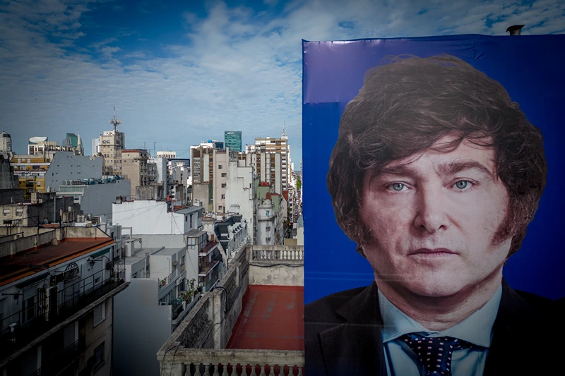 Argentinians Await Change of Government Amid Economic and Social Turmoil
BUENOS AIRES, ARGENTINA - NOVEMBER 30: A Javier Milei picture is seen on a campaign sign on November 30, 2023 in Buenos Aires, Argentina. President-elect Javier Milei of La Libertad Avanza will take office on Sunday 10, replacing incumbent peronist Alberto Fernandez. Milei is a self-described "anarcho-capitalist" libertarian who wants to sharply reduce the size of the State and replace the local peso with the American dollar. During the campaign, he promised to uproot Argentina's political establishment and to align the economy with dramatic measures such as closing the Central Bank. After defeating the current Minister of Economy Sergio Massa in the run-off with 55,65% of the votes, the president-elect has shown moderation and pragmatism as he works on the line up of his cabinet. The new administration will face the challenge to reduce the country's 140% annual inflation and its 44,7% of poverty, as recently announced by a study carried out by ODSA-UCA. (Photo by Tomas Cuesta/Getty Images)