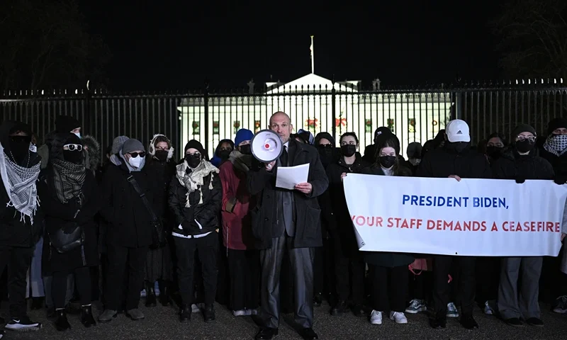 US-PALESTINIAN-ISRAEL-CONFLICT-DEMO Former State Department official and activist Josh Paul (C), that resigned over the war between Israel and Hamas, speaks during a demonstration calling for a ceasefire amid the Hamas-Israel war, in front of the White House in Washington, DC on December 13, 2023. (Photo by Brendan SMIALOWSKI / AFP) (Photo by BRENDAN SMIALOWSKI/AFP via Getty Images)