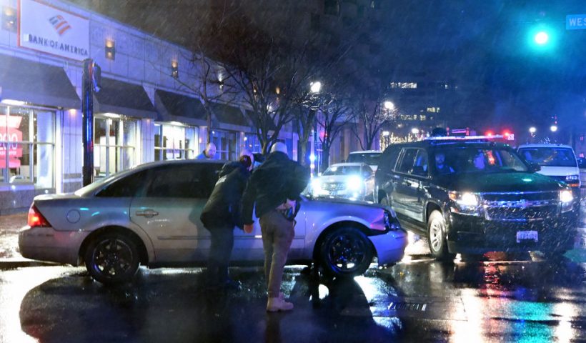 TOPSHOT - Members of the US Secret Service rush to a car, after it hit a motorcade SUV, as US president Joe Biden was leaving his campaign headquarters in Wilmington, Delaware on December 17, 2023. (Photo by ANDREW CABALLERO-REYNOLDS / AFP) (Photo by ANDREW CABALLERO-REYNOLDS/AFP via Getty Images)