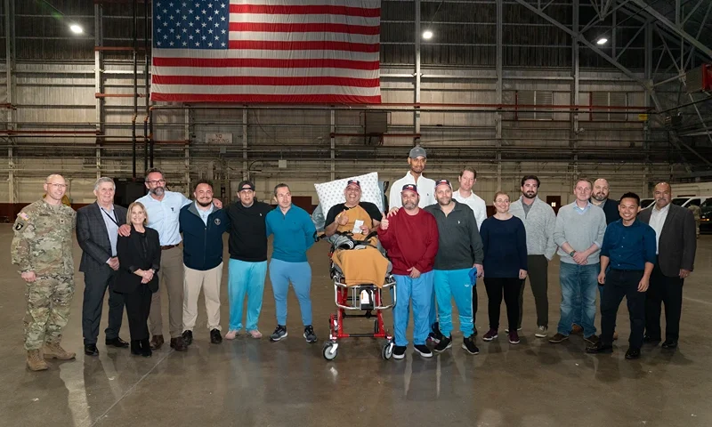 TOPSHOT - Freed US citizens Joseph Ryan Cristella (6th L), Eyvin Hernandez (7th L), Edgar Jose Marval Moreno (8th L) Jason Saad (9th L), Savoi Wright (10th L) and Jerrel Kenemore (8th R) pose for pictures upon arrival at Joint Base San Antonio Kelly Annex in San Antonio, Texas on December 20, 2023, after being freed amid a prisoner swap deal between the United States and Venezuela. The United States released an ally of Venezuelan President Nicolas Maduro in exchange for 10 American detainees and a fugitive dubbed "Fat Leonard" in a sweeping prisoner swap deal between the rival governments December 20, 2023. US President Joe Biden made the "extremely difficult decision" to free Alex Saab, the onetime confidant of socialist leader Maduro, who is accused by the United States of money laundering for Caracas, US officials said. (Photo by SUZANNE CORDEIRO / AFP) (Photo by SUZANNE CORDEIRO/AFP via Getty Images)