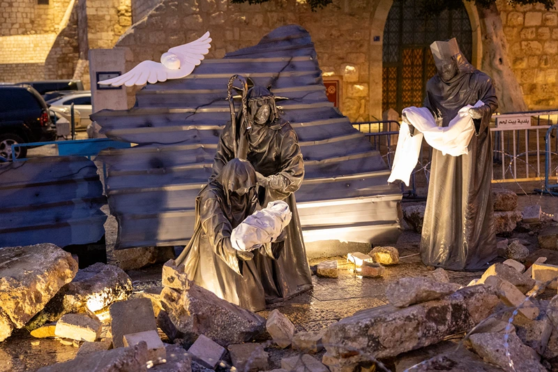 Subdued Christmas Season In Bethlehem, West Bank
BETHLEHEM, WEST BANK - DECEMBER 23: Art work "Nativity under the Rubble" by Palestinian artist Tariq Salsa is seen in Manger Square near the Church of Nativity on December 23, 2023 in Bethlehem, West Bank. Art work shows a Gazan Child instead of Baby Jesus in the scene of rubble. Last month, Christian Palestinian leaders here called off public Christmas celebrations, citing the effects of the ongoing war in Gaza. Regarded by Christians as the birthplace of Jesus, Bethlehem is usually bustling with foreign tourists this time of year, with streets full of holiday decoration and vendors selling ornaments and festive figurines. Israel's war against Hamas that was sparked by the Oct. 7 attacks has also made life more volatile in the West Bank. Israeli forces here have stepped up raids on alleged militants, police have clashed with protesters, and there has been a rise in violent attacks on Palestinians by Israeli settlers. (Photo by Maja Hitij/Getty Images)