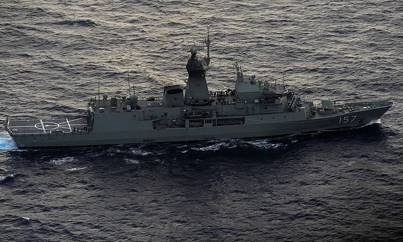 IN FLIGHT - APRIL 11: Seen from the Royal New Zealand Airforce (RNZAF) P-3K2-Orion aircraft, the Australian ship HMAS Perth is guided into position by the RNZAF aircraft to recover a red object during the search for missing Malaysia Airlines flight MH370 in flight over the Indian Ocean on April 13, 2014 off the coast of Perth, Australia. Search and rescue officials in Australia are confident they know the approximate position of the black box recorders from missing Malaysia Airlines Flight MH370, Australian Prime Minister Tony Abbott said on Friday. At the same time, however, the head of the agency coordinating the search said that the latest "ping" signal, which was captured by a listening device buoy on Thursday, was not related to the plane. (Photo by Greg Wood - Pool/Getty Images)