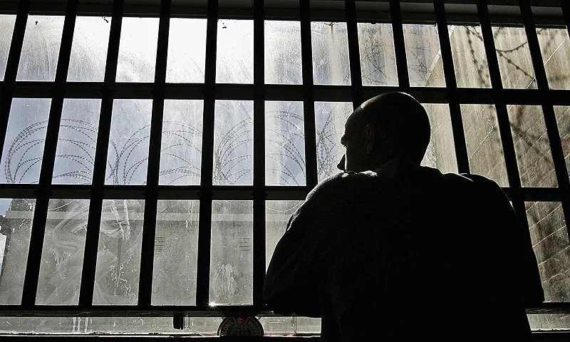 NORWICH, UNITED KINGDOM - AUGUST 25: (EDITORS NOTE: IMAGES EMBARGOED FOR PUBLICATION UNTIL 0001GMT AUGUST 26, 2005) 19 year old inmate James looks out of the window of the Young Offenders Institution attached to Norwich Prison on August 25, 2005 in Norwich, England. A Chief Inspector of Prisons report on Norwich Prison says healthcare accommodation was among the worst seen, as prisoners suffered from unscreened toilets, little natural light, poor suicide prevention, inadequate education and training for long-term prisoners. (Photo by Peter Macdiarmid/Getty Images)