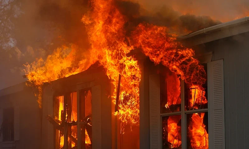 JAMUL, CA - OCTOBER 24: A home burns in Deerhorn Valley as the Harris Fire continues growing beyond 70,000 acres on October 24, 2007 near Jamul, California. Southern California is being ravaged by numerous record wildfires as Santa Ana Wind conditions push them into communities surrounded by native Chaparral habitat that has been dried by the driest rain season since records began 130 years ago. The fires are shaping up to be the worst wildfire event in San Diego County history. As many as 500,000 people have been evacuated from their homes. (Photo by David McNew/Getty Images)