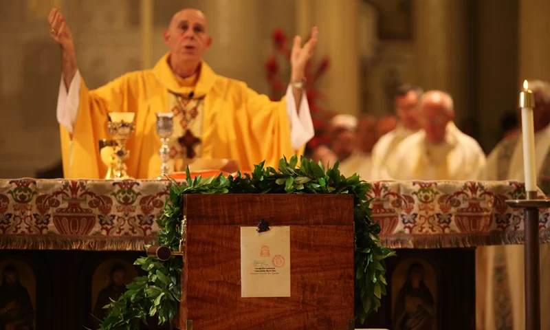 Bishop Larry Silva celebrates mass in honor of Saint Damien at Cathedral of Our Lady of the Peace fronting Saint Damien's relic, November 01, 2009 in Honolulu, Hawaii. Hawaii feted the canonization of Saint Damien with a Mass and an interfaith celebration that underscored the 19th century priest's enduring popularity in the islands. The Hawaii commemorations came several weeks after the Vatican made Damien, born in Belgium as Joseph de Veuster in 1840, a saint in a ceremony presided over by Pope Benedict XVI in Rome. Father Damien or Saint Damien of Molokai, SS.CC. (January 3, 1840 � April 15, 1889), born Jozef De Veuster, was a Roman Catholic priest from Belgium and member of the Congregation of the Sacred Hearts of Jesus and Mary, a missionary religious order. He won recognition for his ministry to people with leprosy. AFP PHOTO CORY LUM AFP PHOTO/Cory LUM (Photo credit should read Cory LUM/AFP via Getty Images)