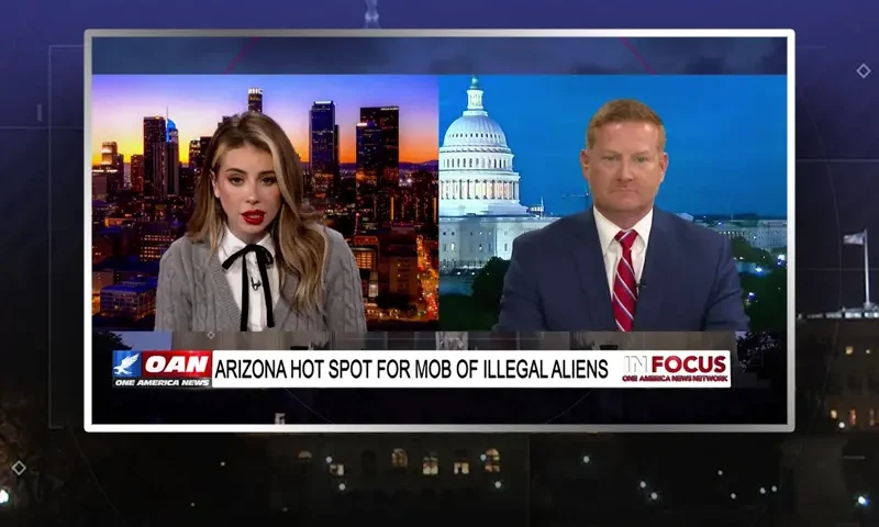 Video still from In Focus on One America News Network showing a split screen of the host on the left side, and on the right side is the guest, Clint Dorris.