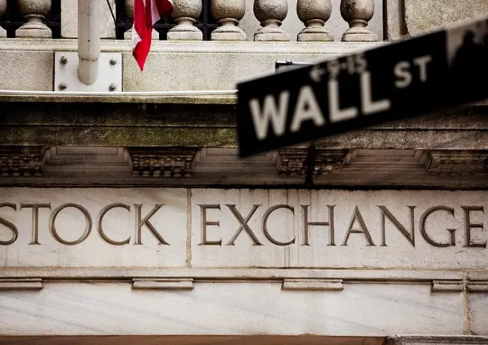 A street sign for Wall Street hangs in front of the New York Stock Exchange May 8, 2013. REUTERS/Lucas Jackson