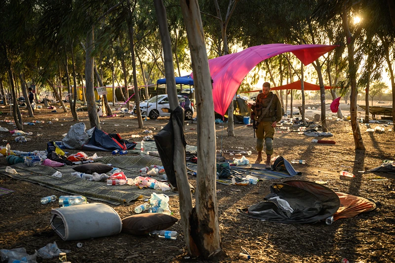 RE'IM, ISRAEL - OCTOBER 12: Members of the security forces continue to search for identification and personal effects at the Supernova Music Festival site, where hundreds were killed and dozens taken by Hamas militants near the border with Gaza, on October 12, 2023 in Kibbutz Re'im, Israel. Israel has sealed off Gaza and launched sustained retaliatory air strikes, which have killed at least 1,200 people with more than 300, 000 displaced, after a large-scale attack by Hamas. On October 7, the Palestinian militant group Hamas launched a surprise attack on Israel from Gaza by land, sea, and air, killing over 1,200 people and wounding around 2800. Israeli soldiers and civilians have also been taken hostage by Hamas and moved into Gaza. The attack prompted a declaration of war by Israeli Prime Minister Benjamin Netanyahu and the announcement of an emergency wartime government. (Photo by Leon Neal/Getty Images)