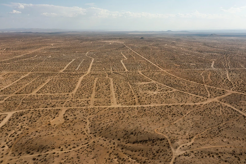 TOPSHOT-US-CALIFORNIA-HOUSING-REAL ESTATE
TOPSHOT - In this aerial picture taken on September 25, 2021 a vast network of roads cut in the Mojave Desert, intended for a massive suburban paradise that was never built, in California City, California, approximately 100 miles (160 km) north of Los Angeles. - Envisioned as a family-friendly suburban utopia by a 1950's-era real estate developer who wanted to recreate the success of desert cities such as Palm Springs and Las Vegas, he and a team of salespeople sold the dream to thousands of people. Designs for multiple subdivisions with cul de sacs and sprawling infrastructure were drawn, roads built, street signs posted and water and sewer infrastructure were installed but the vast majority of homes never built. Despite it's relatively tiny population of a little more than 14,000 residents, California City is the third largest city in the state of California by land mass approximately 203 square miles (527 km2). While the city is currently slowly growing a Starbucks opened in the central downtown area this week it is still mostly unpopulated and unknown. (Photo by Robyn Beck / AFP) (Photo by ROBYN BECK/AFP via Getty Images)