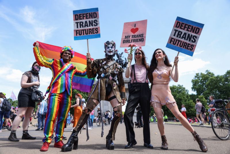LONDON, ENGLAND - JULY 09: Demonstrators pose holding placards ahead of the London Trans Pride protest on July 9, 2022 in London, England. Trans rights activists took to the streets of central London this weekend to march for the fourth year under the slogan, Pride is a Protest at Trans+ Pride. (Photo by Hollie Adams/Getty Images)