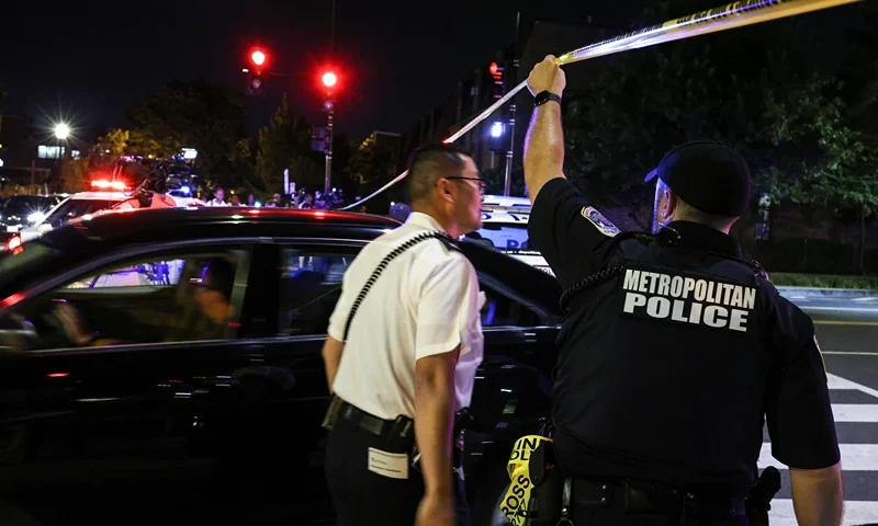 Multiple People Injured In Washington, DC Shooting WASHINGTON, DC - JULY 22: A police officer holds up caution tape near the site of a shooting on July 22, 2021 in Washington, DC. Gunfire erupted on a busy street, injuring two and sending others fleeing for safety. A dark sedan was being sought in connection with the shooting and the two injured were expected to survive, according to published reports. (Photo by Anna Moneymaker/Getty Images)