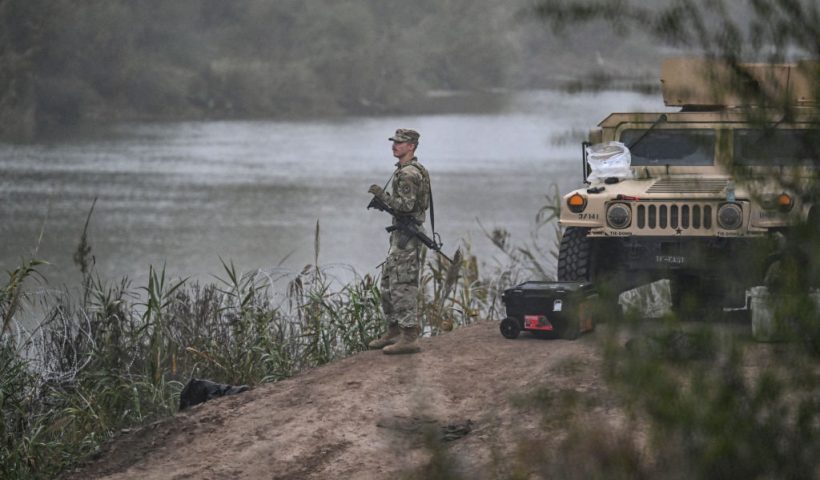 A US National Guard soldier guards the border with Mexico at Eagle Pass, Texas, on December 23, 2023. Faced with the daily arrival of thousands of migrants from Mexico, US states and federal border police are declaring themselves overwhelmed, a crisis that is exposing the administration of US President Joe Biden to heavy fire from its Republican opponents. In recent weeks, the border police have reported some 10,000 people crossing the border every day, an even faster pace than in previous months. (Photo by CHANDAN KHANNA / AFP) (Photo by CHANDAN KHANNA/AFP via Getty Images)