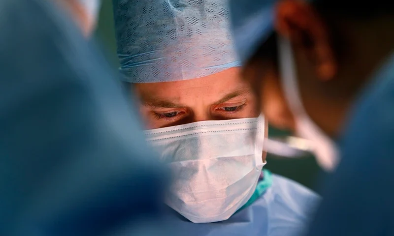 The Duke Of Cambridge Visits The Royal Marsden, Chelsea SUTTON, UNITED KINGDOM - NOVEMBER 07: Prince William, Duke of Cambridge, in his role as President of the Royal Marsden NHS (National Health Service) Foundation Trust, watches as lead surgeon Pardeep Kumar, performs surgery for the removal of a bladder tumour on a male patient during a visit to the Royal Marsden Hospital on November 07, 2013 in Sutton, Greater London. (Photo by Lefteris Pitarakis - WPA Pool/Getty Images)