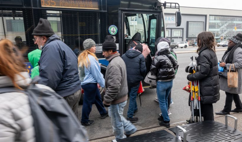 NEW YORK, NEW YORK - JANUARY 04: Recently arrived migrants board a bus back to their temporary tent shelters at Floyd Bennett Field, a former airfield in Brooklyn, on January 04, 2024 in New York City. The isolated location on a road that leads to the Atlantic Ocean has forced migrants to depend on limited sources of transportation to get to schools, work or other locations. The 2,000-bed shelter, which opened in November to house migrant families, was chosen after the Eric Adams administration said hotels and other places of shelter had hit capacity, after New York became the main destination for buses from Texas. (Photo by Spencer Platt/Getty Images)