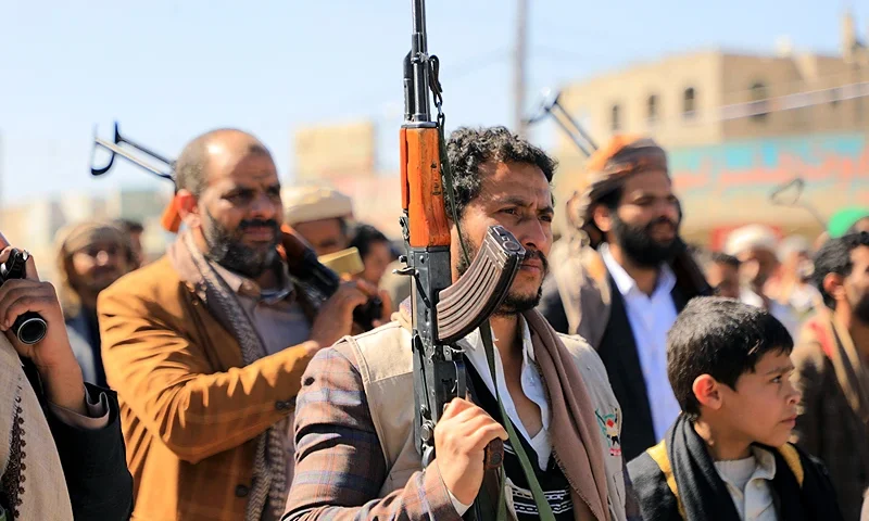 Huthi fighters brandish their weapons during a march in solidarity with the Palestinian people in the Huthi-controlled capital Sanaa on January 11, 2024, amid the ongoing battles between Israel and the militant Hamas group in Gaza. Heavy air strikes pounded rebel-held cities in Yemen early on January 12, 2024, the Huthi rebels' official media and AFP correspondents said. The capital Sanaa, Hodeida and Saada were all targeted, the Huthis' official media said, blaming "American aggression with British participation". (Photo by MOHAMMED HUWAIS / AFP) (Photo by MOHAMMED HUWAIS/AFP via Getty Images)