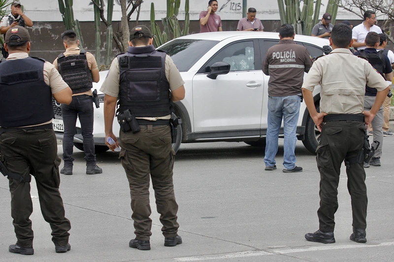 ECUADOR-STATE OF EMERGENCY-SECURITY-MURDER-PROSECUTOR-SUAREZ
Members of the National Police inspect the car in which Prosecutor Cesar Suarez was at the moment he was shot dead in Guayaquil, Ecuador on January 17, 2024. A prosecutor charged with investigating the dramatic live-broadcast armed assault last week on an Ecuadoran television station was shot dead Wednesday, the country's attorney general said. "In the face of the murder of our colleague Cesar Suarez ... I am going to be emphatic: organized crime groups, criminals, terrorists will not stop our commitment to Ecuadoran society," said Attorney General Diana Salazar in a statement on X. (Photo by STRINGER / AFP) (Photo by STRINGER/AFP via Getty Images)
