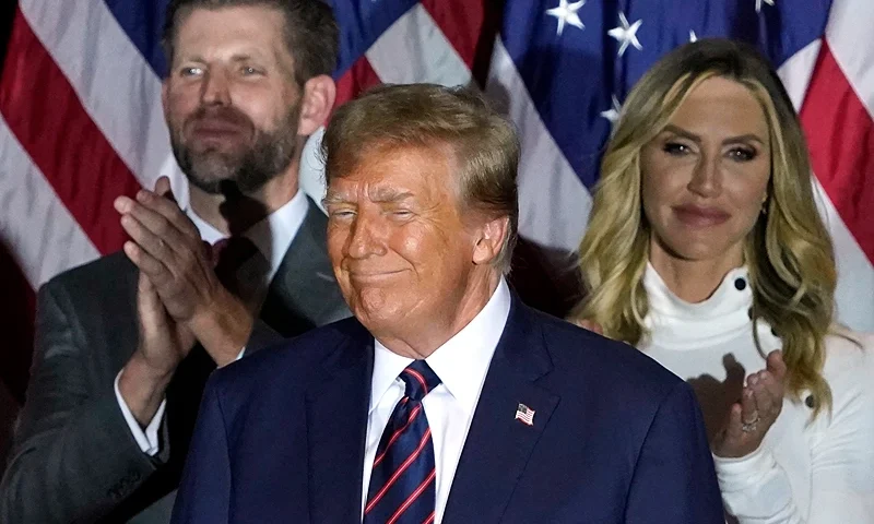 Republican presidential hopeful and former US President Donald Trump looks on, flanked by son Eric Trump (L) and daughter-in-law Lara Trump, during an Election Night Party in Nashua, New Hampshire, on January 23, 2024. Donald Trump won the key New Hampshire primary Tuesday, moving him ever closer to locking in the Republican presidential nomination and securing an extraordinary White House rematch with Joe Biden. (Photo by TIMOTHY A. CLARY / AFP) (Photo by TIMOTHY A. CLARY/AFP via Getty Images)
