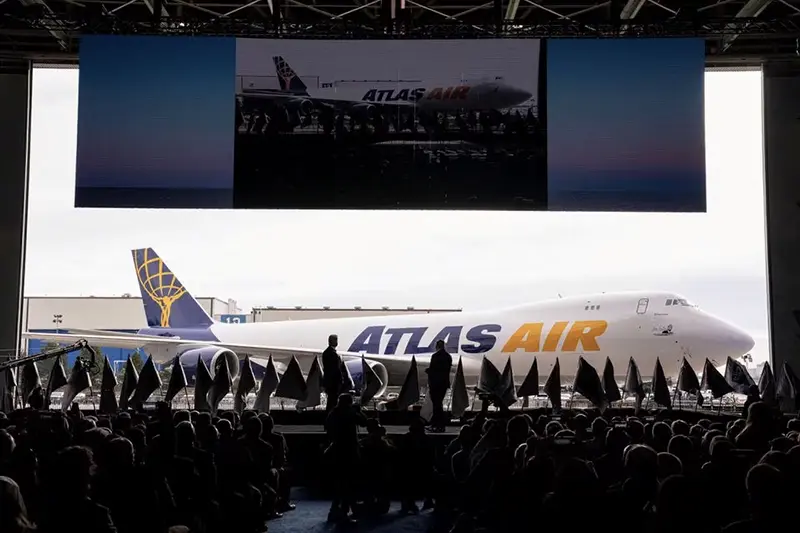 John W. Dietrich, president and CEO of Atlas Air Worldwide, and Dave Calhoun, CEO of Boeing, converse on stage during the delivery of the final 747 jet at their plant in Everett, Washington, U.S. January 31, 2023. REUTERS/David Ryder/File Photo