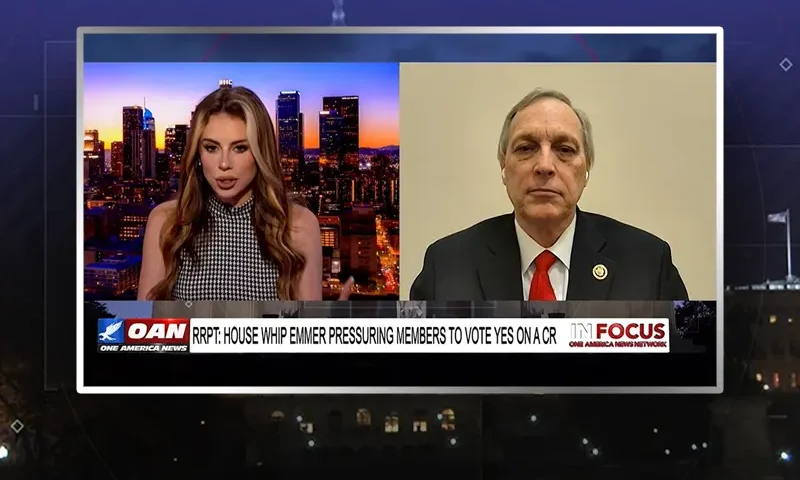 Video still from In Focus on One America News Network showing a split screen of the host on the left side, and on the right side is the guest, Rep. Andy Biggs.