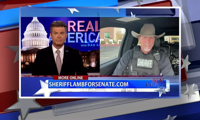 Video still from Real America on One America News Network showing a split screen of the host on the left side, and on the right side is the guest, Sheriff Mark Lamb.