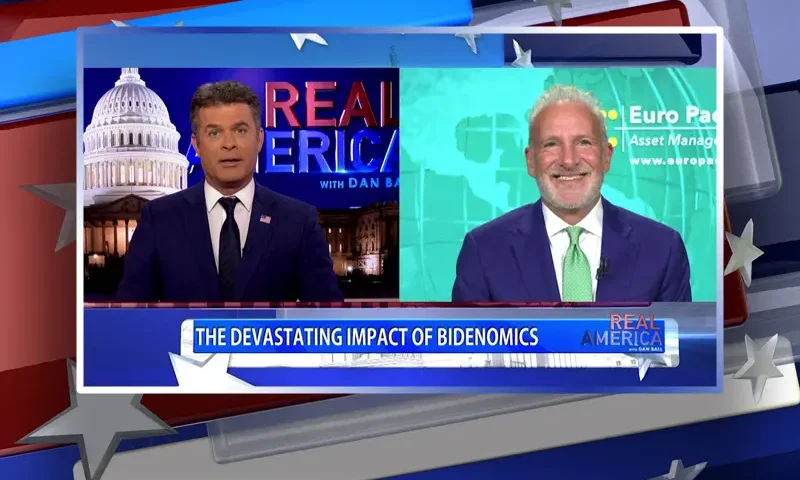 Video still from Real America on One America News Network showing a split screen of the host on the left side, and on the right side is the guest, Peter Schiff.