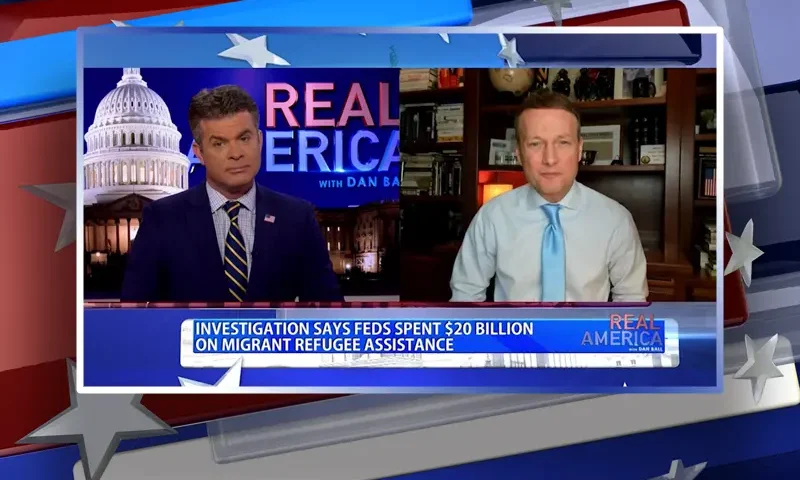 Video still from Real America on One America News Network showing a split screen of the host on the left side, and on the right side is the guest, Adam Andrzejewski.