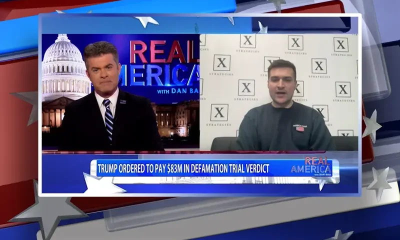 Video still from Real America on One America News Network showing a split screen of the host on the left side, and on the right side is the guest, Alex Bruesewitz.