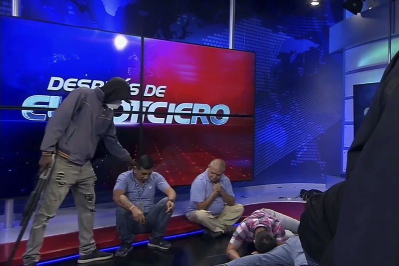2 of 12
This screen grab of live video from the TC Television network shows a masked, armed person standing over journalists during a live broadcast, in Guayaquil, Ecuador, Tuesday, Jan. 9, 2024. The country has seen a series of attacks after the government imposed a state of emergency in the wake of the apparent escape of a powerful gang leader from prison. (TC Television network via AP)