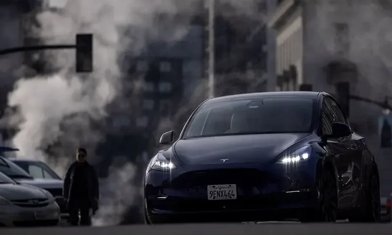 A person drives a Tesla vehicle as the company is recalling over 2 million vehicles in the U.S. to install new safeguards in its Autopilot advanced driver-assistance system, after a federal safety regulator cited safety concerns, in downtown San Francisco, California, U.S. December 14, 2023. REUTERS/Carlos Barria/File Photo