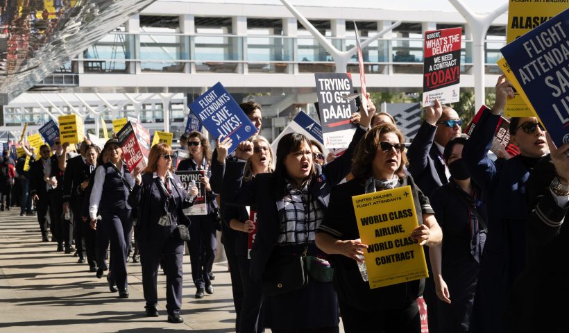 Flight attendants walk picket line at Los Angeles International Airport on Tuesday, Feb. 13, 2024. Flight attendants for major U.S. airlines are holding rallies at airports around the country to push for higher pay. Tuesday's protests are not, however, a strike. Federal law makes it difficult for airline unions to go on strike. (AP Photo/Richard Vogel)