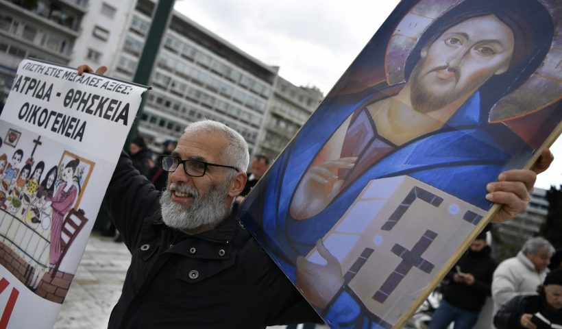 A protester holding a Holy Icon takes part in a rally against same-sex marriage, at central Syntagma Square, in Athens, Greece, Thursday, Feb. 15, 2024. Greece's parliament is to vote Thursday to legalize same-sex civil marriage in a first for an Orthodox Christian country and despite opposition from the influential Greek Church. (AP Photo/Michael Varaklas)