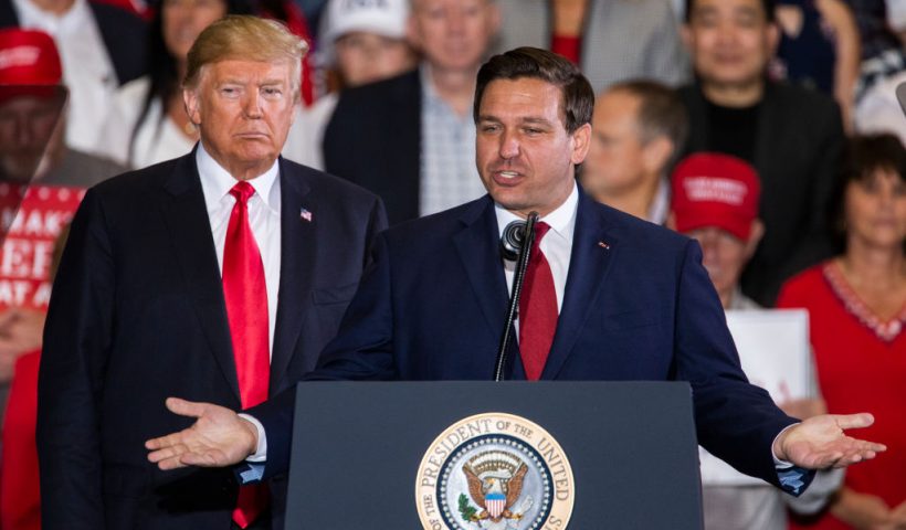 PENSACOLA, FL - NOVEMBER 03: Florida Republican gubernatorial candidate Ron DeSantis speaks with U.S. President Donald Trump at a campaign rally at the Pensacola International Airport on November 3, 2018 in Pensacola, Florida. President Trump is campaigning in support of Republican candidates in the upcoming midterm elections. (Photo by Mark Wallheiser/Getty Images)